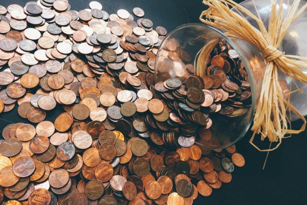 A pile of copper-colored coins, representing the financial considerations when understanding What is the Difference Between NRE and NRO Accounts.